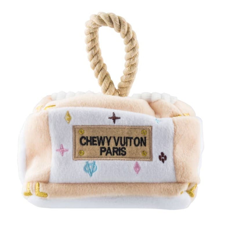 Cream plush dog activity house toy with rope handle and 'CHEWYVUITON PARIS' patch
