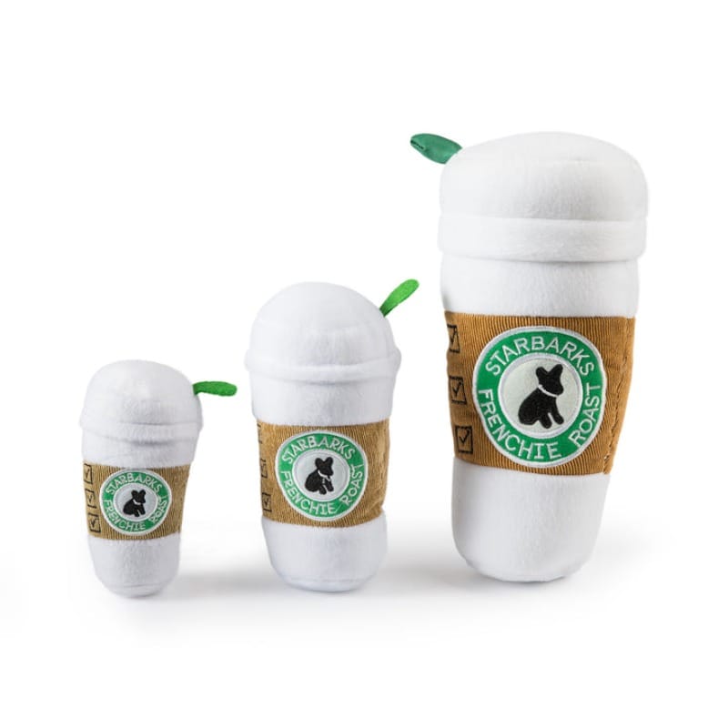 Set of three white plush coffee cup dog toys with green leaf caps.