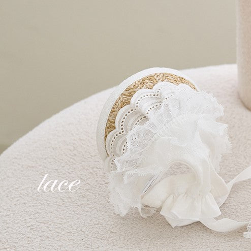 White lace straw hat with scalloped lace brim and bow