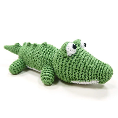 Green crocheted alligator plush with white belly, black-and-white eyes, and small feet.