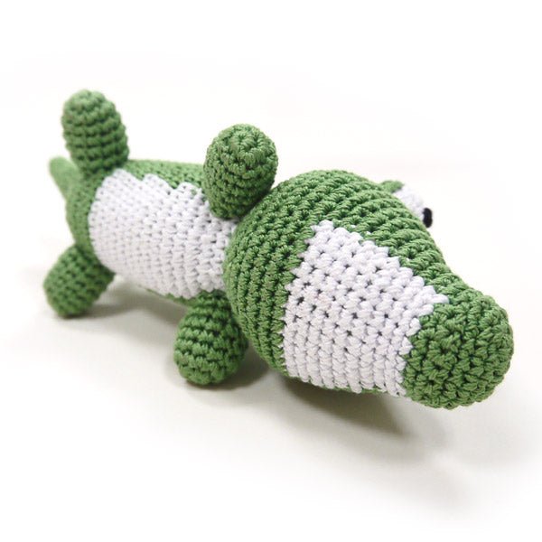 Green and white crocheted alligator plush with white belly panel and raised tail.