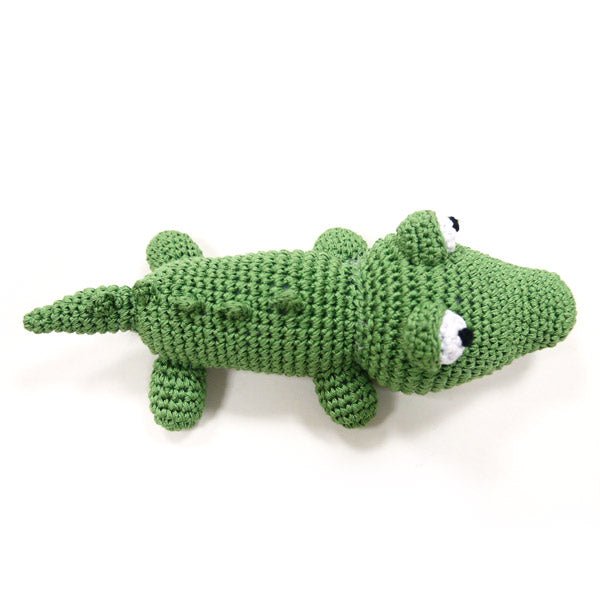 Green crocheted alligator plush lying down with long tail and small legs.