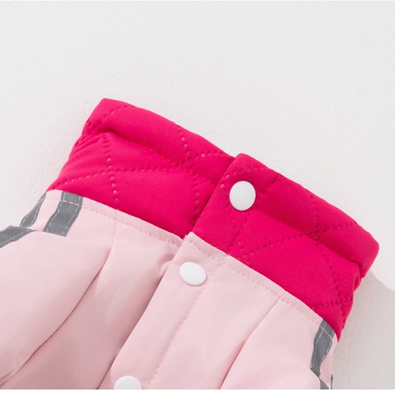 Fuchsia padded dog jacket detail with light pink panels and white snap buttons