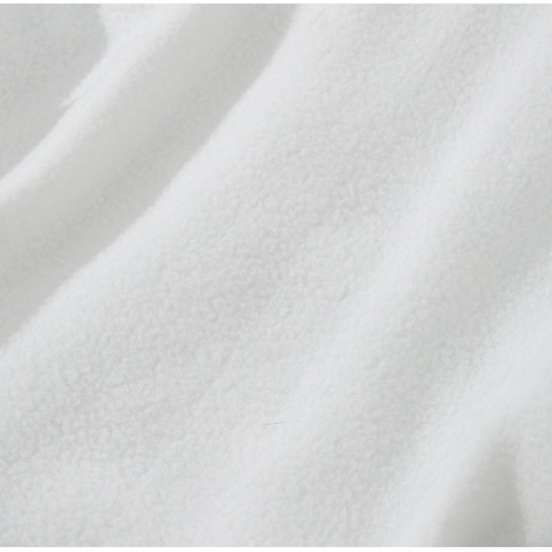 White fabric close-up with soft, matte texture and fine surface grain