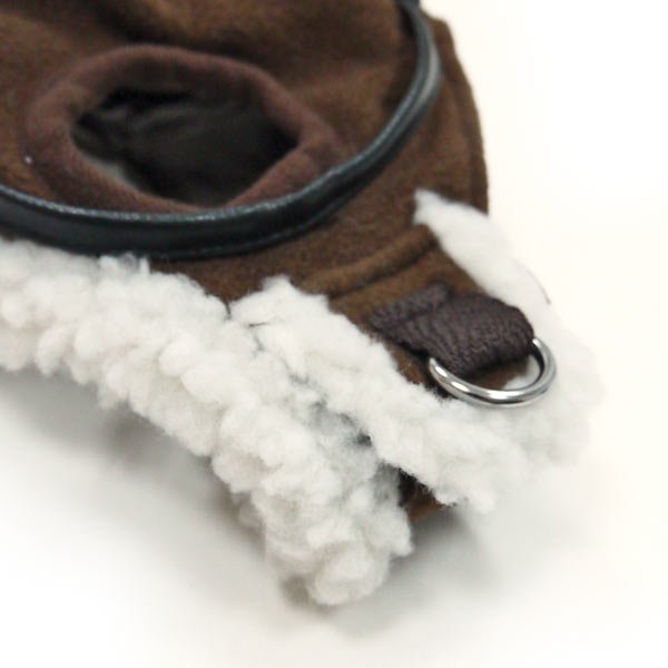 Close-up of brown hat edge with white fleece trim and metal ring clasp