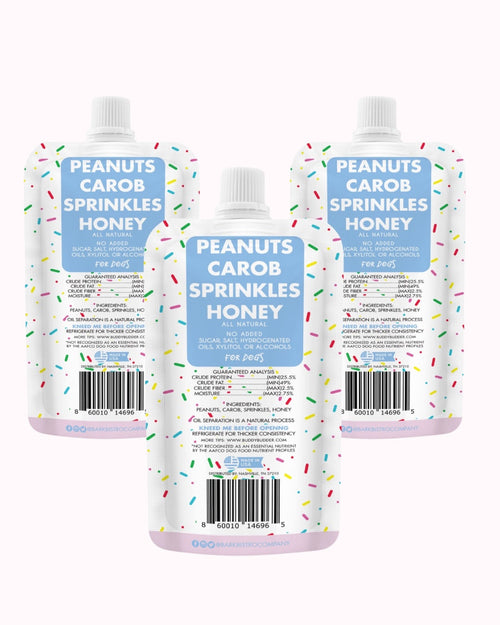 Three dog peanut butter squeeze packs showing ingredient label backs, white caps
