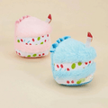 Plush birthday-cake dog toys, pink and blue, with candle toppers and sprinkle print