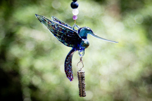 Blue hummingbird ornament with spotted wings, dangling charm and bead strand