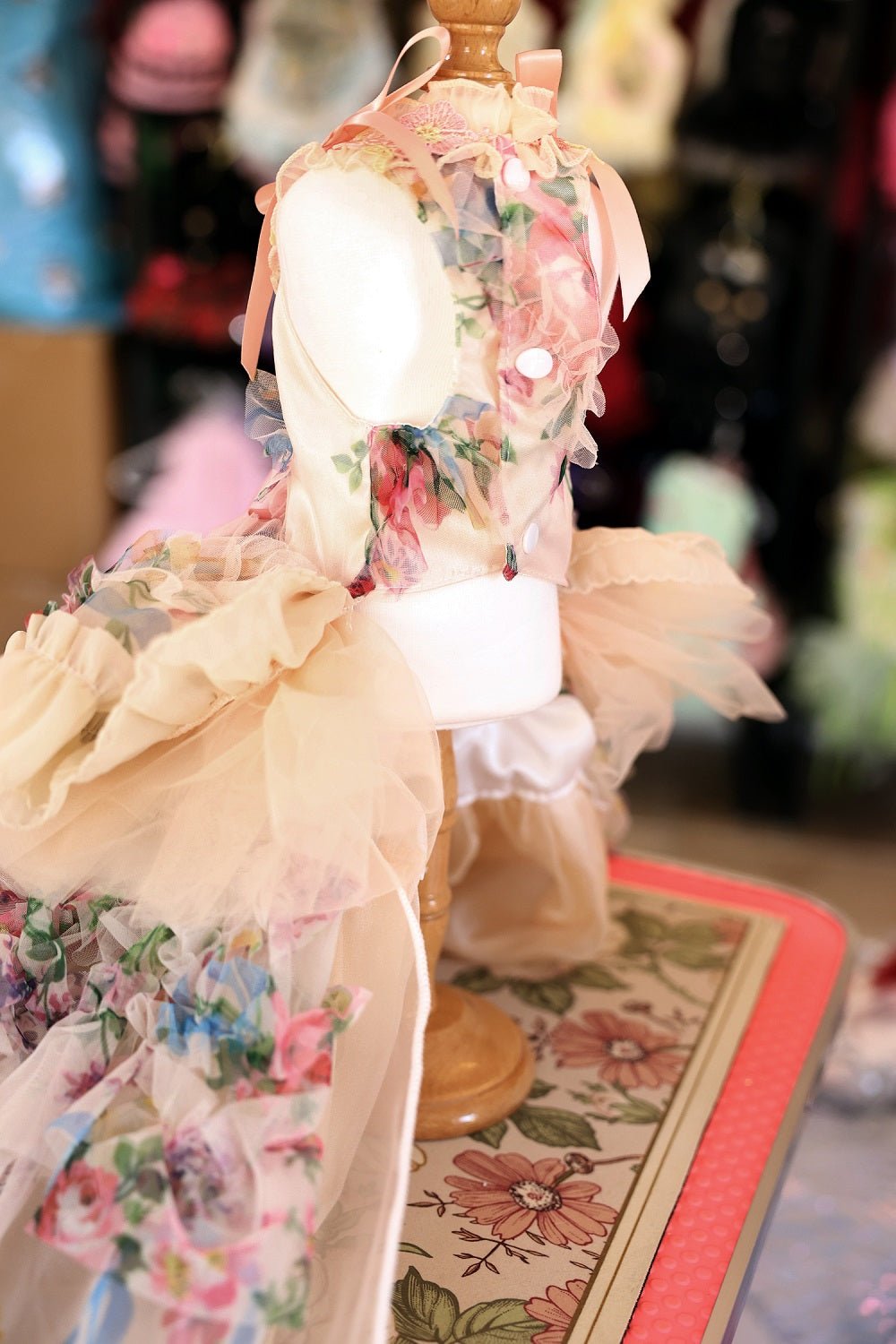 Back view of floral pastel dog dress with bow train and tiered tulle skirt