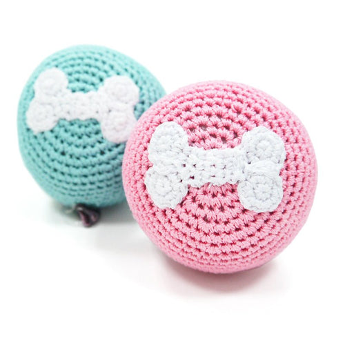Crochet bone ball toy set: teal and pink balls with white bone appliques.