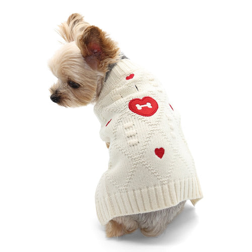 Cream knit dog sweater with red heart and bone patches, dog wearing