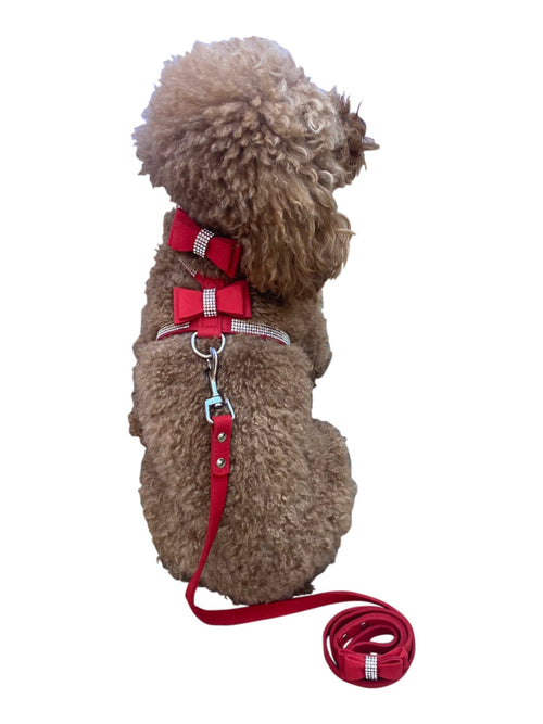 Side view of red pleather bow tie dog harness with leash strap and D-ring