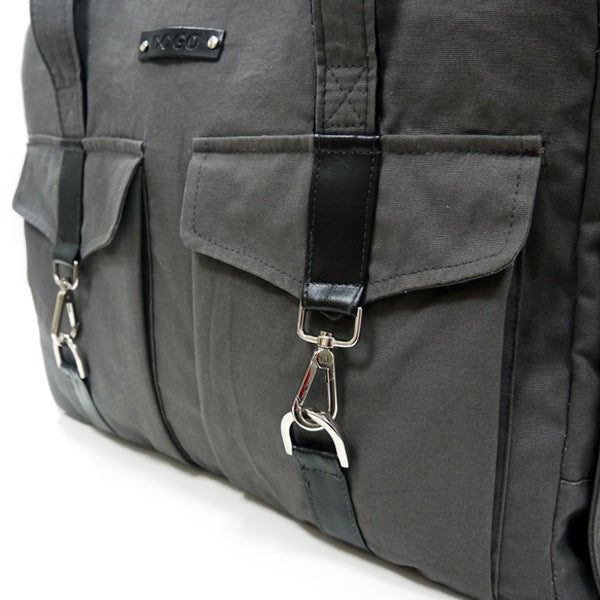 Charcoal buckle tote close-up: front flap pocket with metal D-ring key clips