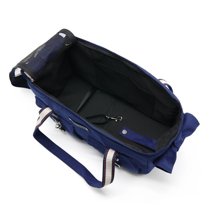Navy tote bag with open top, interior pockets, and front buckle strap
