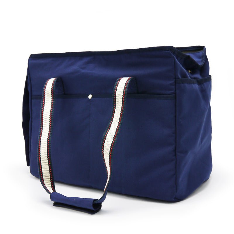 Navy tote bag with reinforced corners, front straps, and top handle