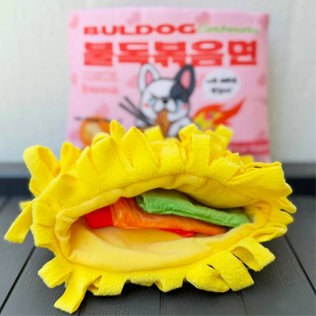 Plush ramen noodle ring revealing green and red insert layers