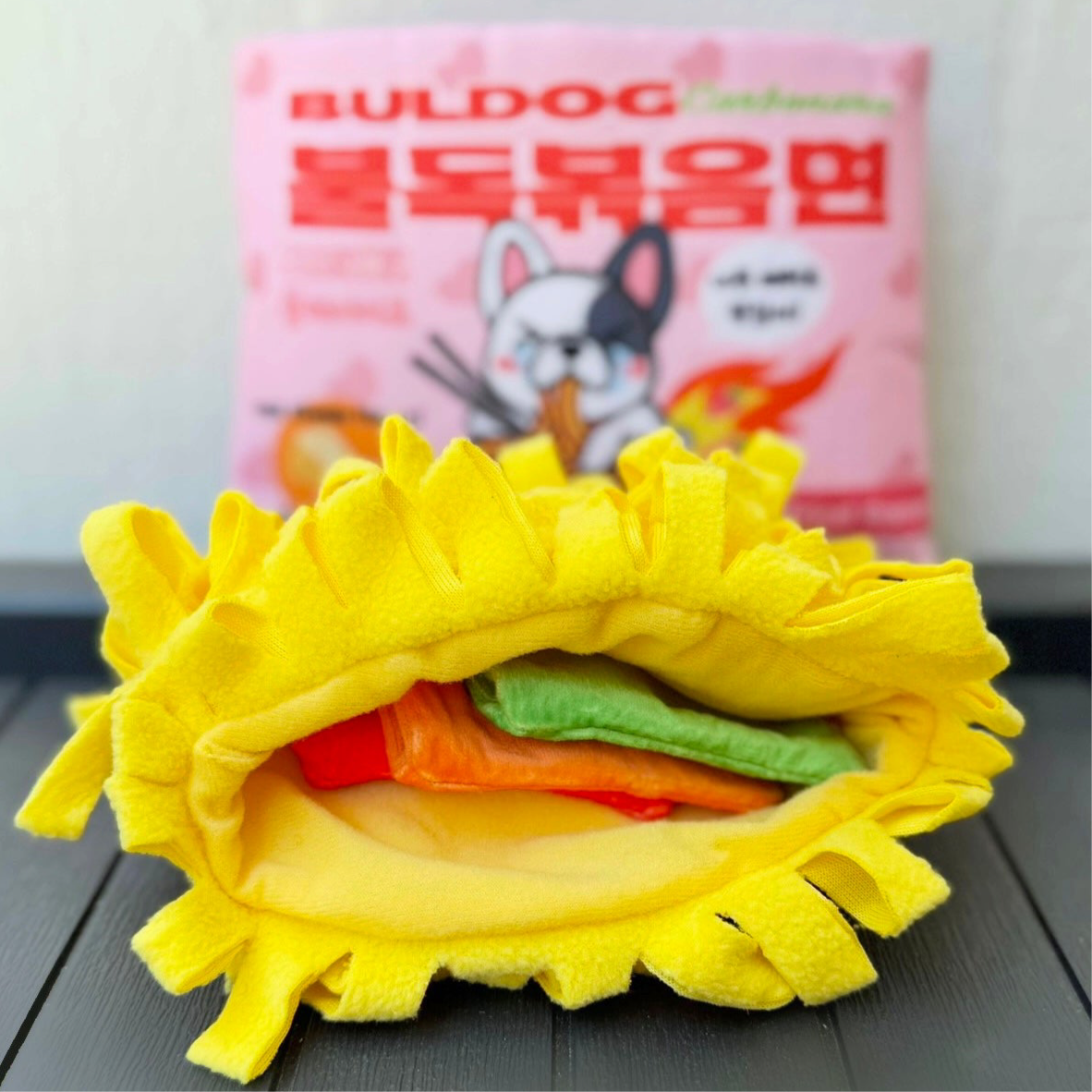 Plush ramen noodle ring revealing green and red insert layers