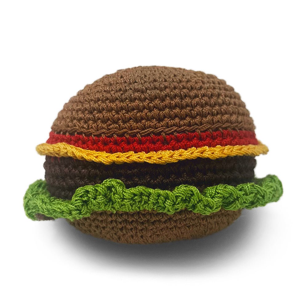 Crochet burger toy with brown bun, red patty, yellow cheese, and green lettuce