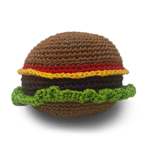 Crochet burger toy with brown bun, red patty, yellow cheese, and green lettuce