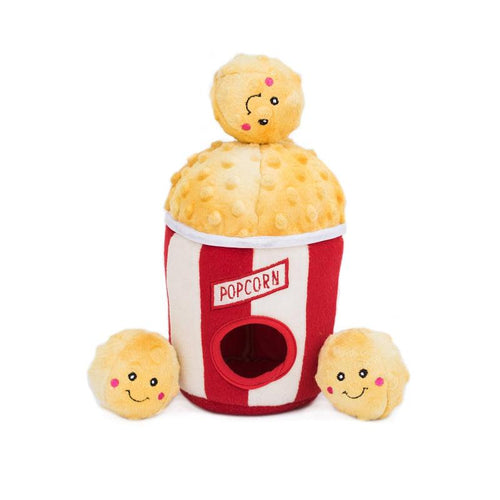 Plush popcorn bucket dog toy with yellow popcorn top, red-and-white body, and three plush kernels