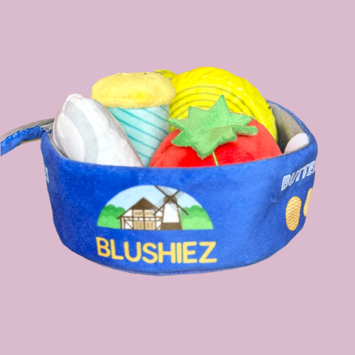 Blue plush cookie-tin dog toy with open top, stuffed felt treats and green star