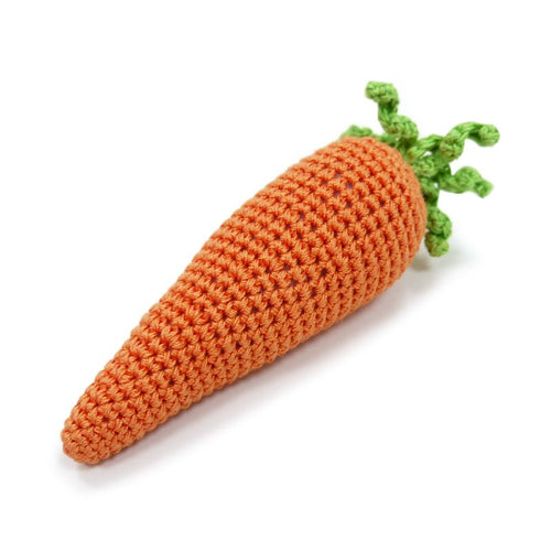 Crocheted orange carrot toy with green sprout-like leaves, angled view
