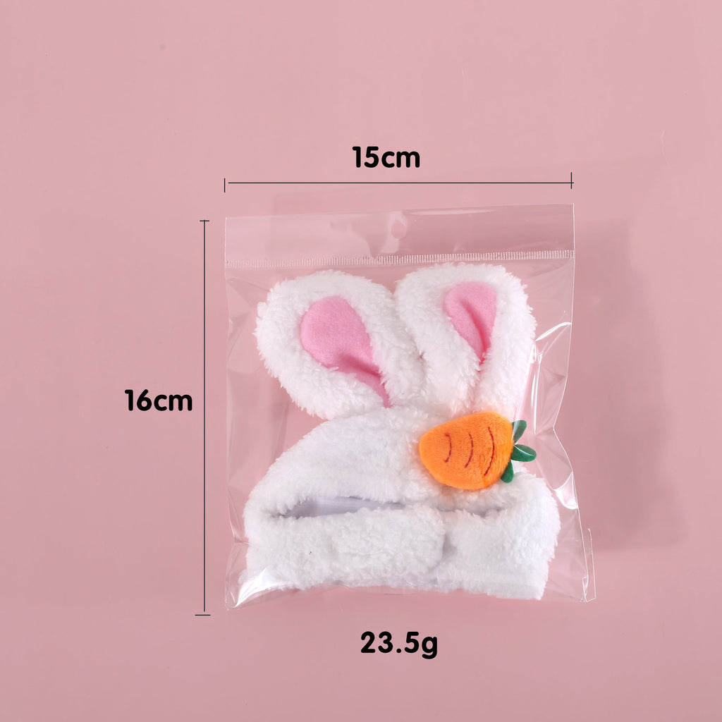 Packaged white plush bunny-eared Easter hat with carrot patch, size shown
