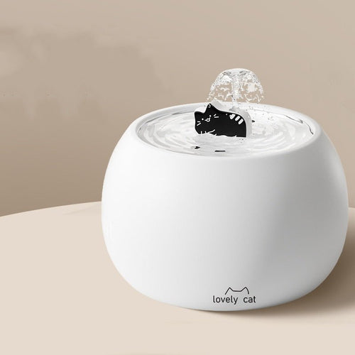 White ceramic pet water fountain with cartoon cat spout and bubbling water dish