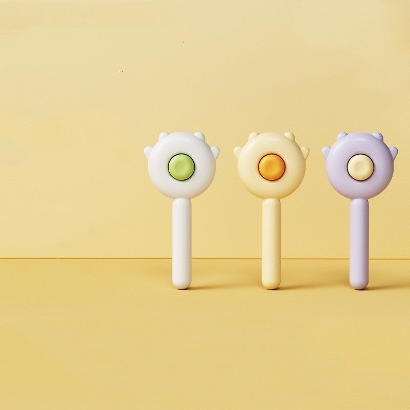 Set of three handheld pet grooming massage brushes with round pin heads and colored buttons