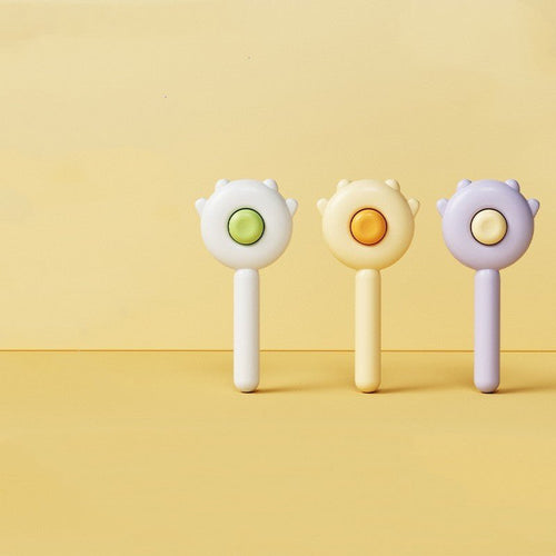 Set of three handheld pet grooming massage brushes with round pin heads and colored buttons