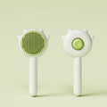 Two white handheld pet grooming brushes with round pin heads and green center button