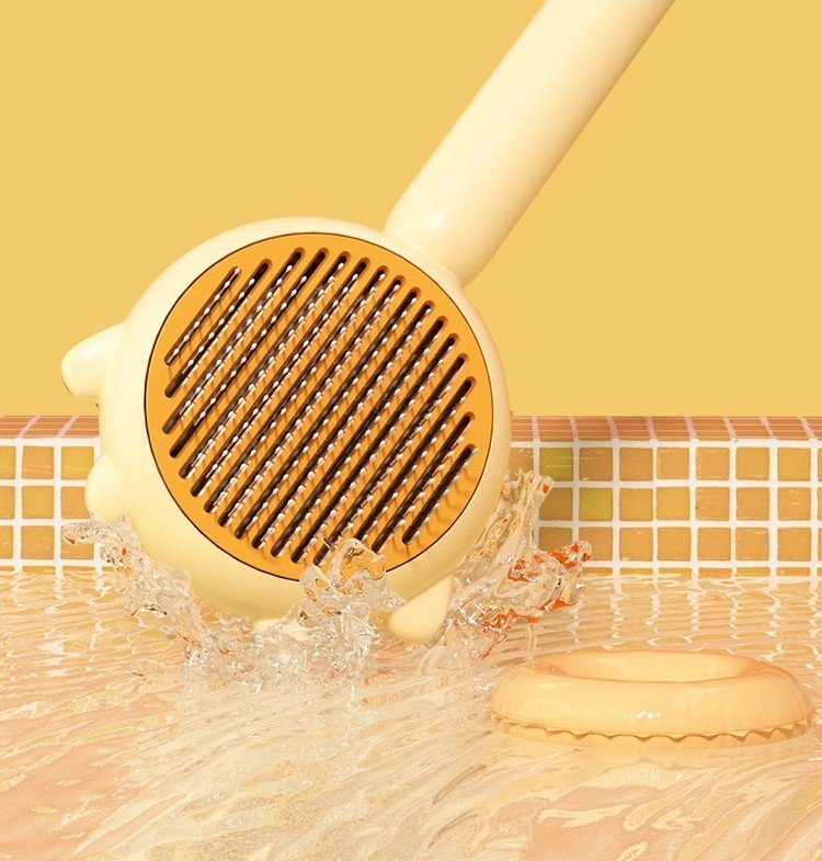 Cream massage pet brush with brown pin head, shown splashing with water