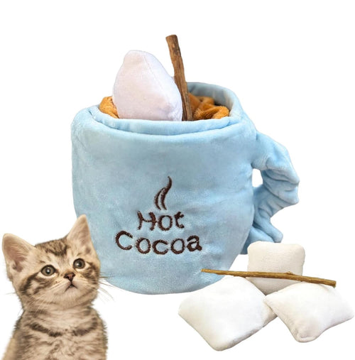 Blue plush cat treat puzzle cup toy with Hot Cocoa label, stick, and white cloth treats