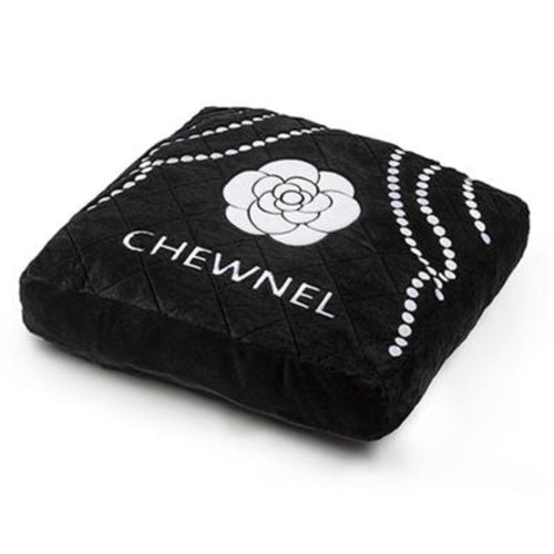 Noir pet bed: black quilted cushion shown at angle with white flower and CHEWNEL logo