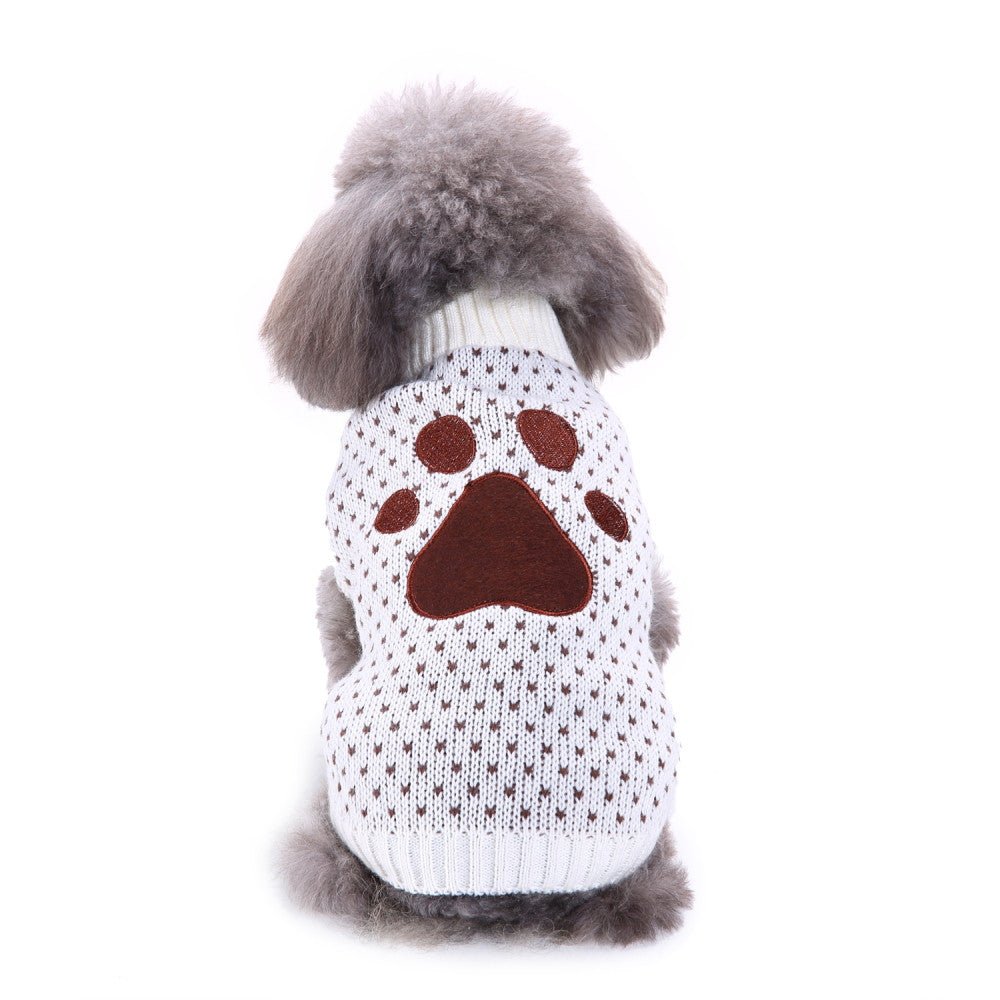Dog sweater in white knit with brown paw graphic and ribbed collar, worn on small dog