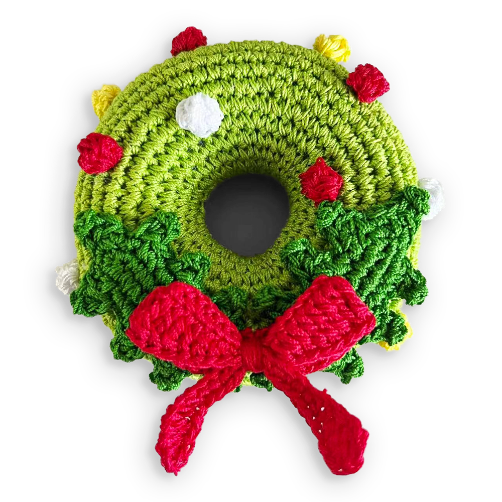 Crochet wreath toy with green round crochet, red bow, berries, and white holly