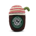 Crochet coffee cup toy, dark brown body, cream/pink striped top, green handle, logo patch