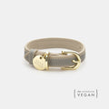 Grey vegan leather dog collar with gold buckle and round logo nameplate tag
