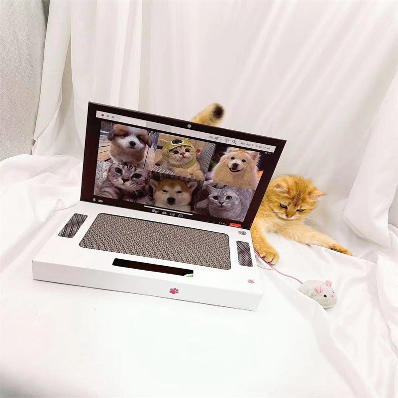 White laptop-style cat scratch board with dark scratching pad and small cat toy items