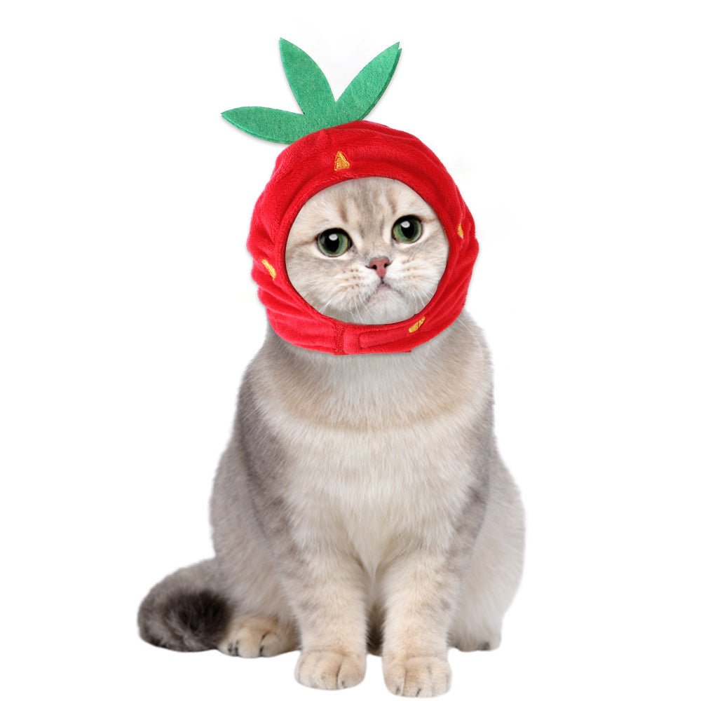 Red plush pet hat with green leaf crown and a round face opening