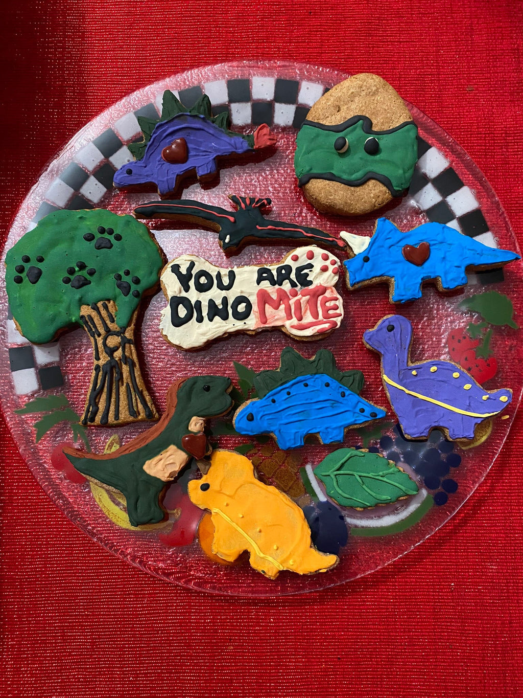 Dinosaur dog cookie tray with “You Are Dino-Mite” cookie and assorted dinosaur shapes