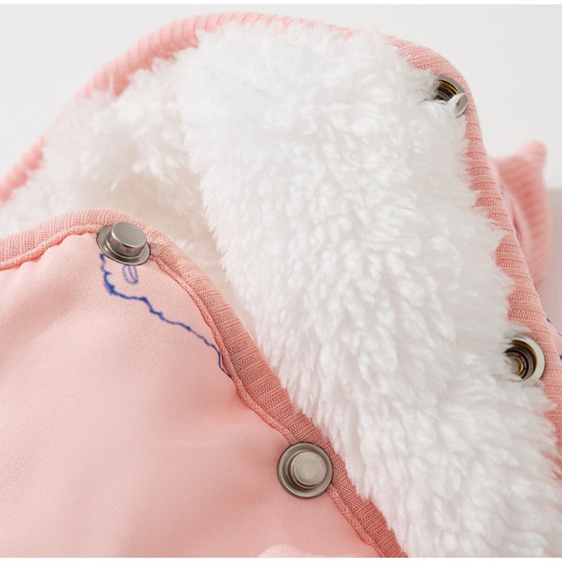 Pink dog cotton coat with white fuzzy lining and round metal button front close-up