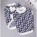 Dog sweater with navy-and-white knit logo pattern, ribbed crew neck and cuffs
