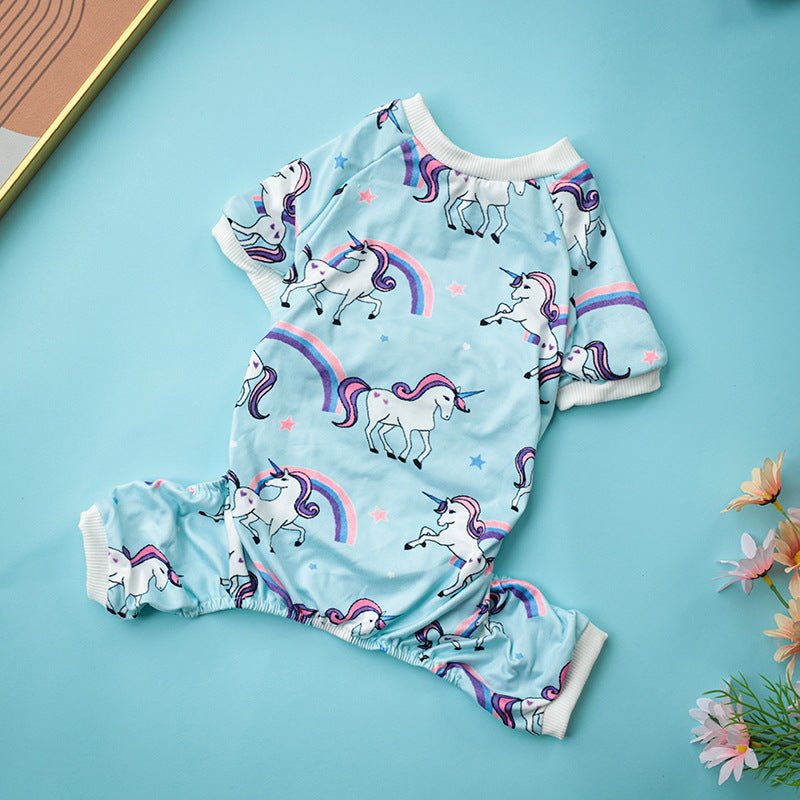 Dog pajama one-piece with unicorns and rainbows, light blue base and white cuffs.