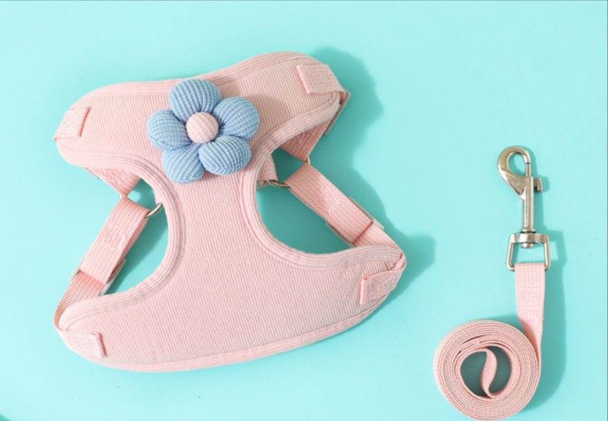 Pink vest-style chest harness with rope leash and blue flower decoration