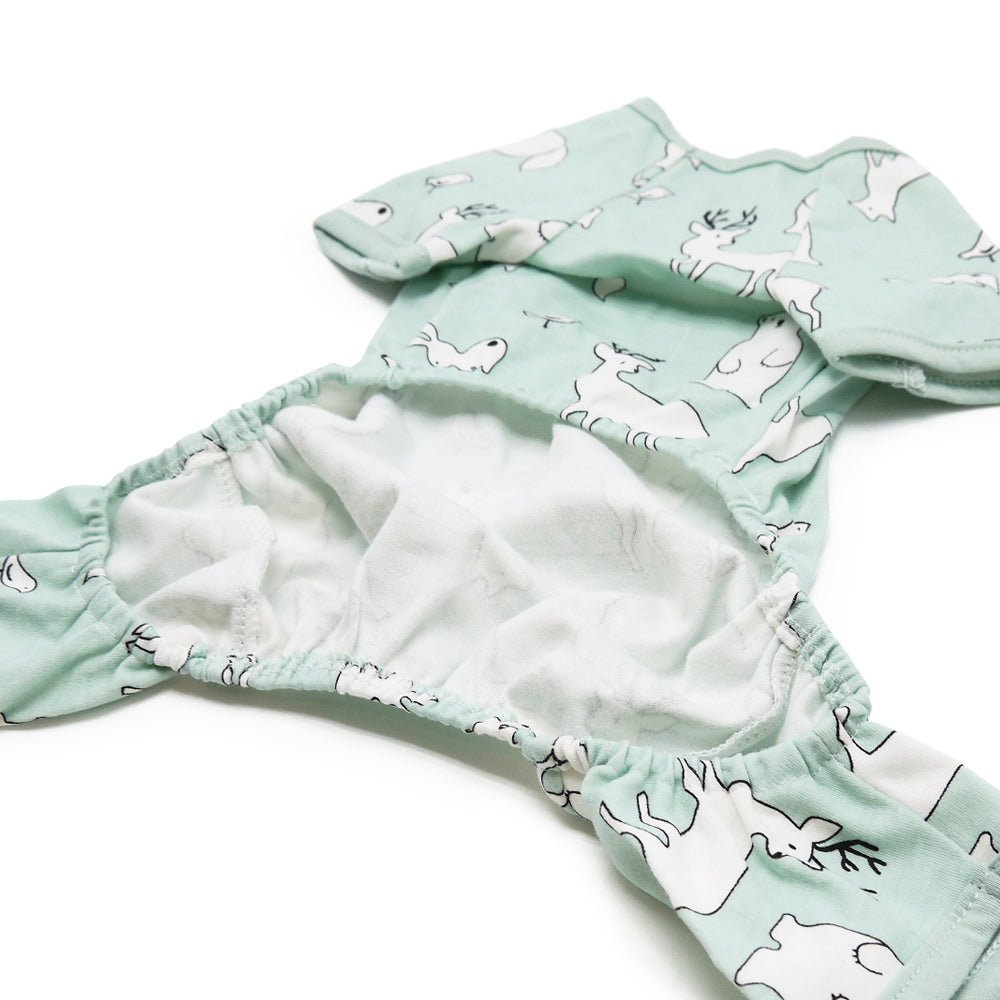 Teal pet pajamas with white animal print fabric and gathered cuffs, close-up