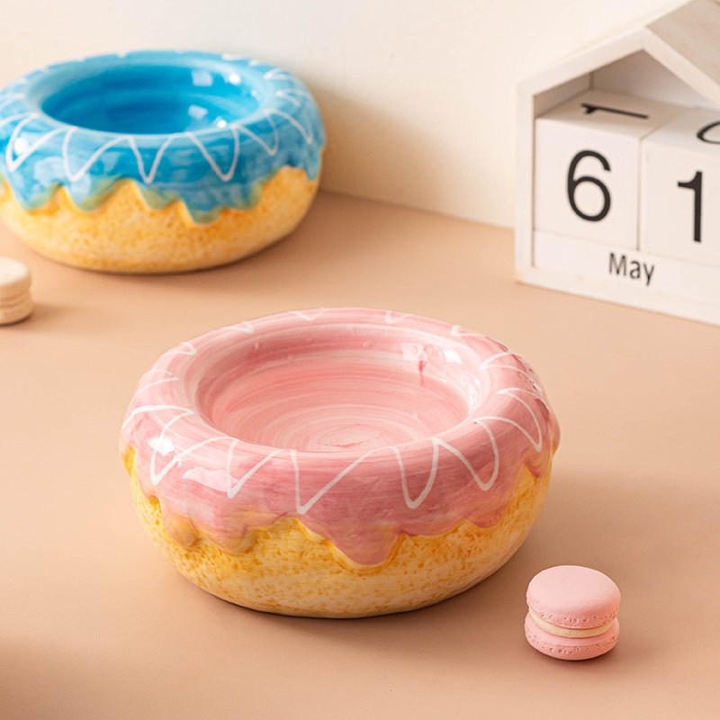 Donut ceramic pet bowl with blue and pink glazes, white swirl pattern along the rim