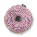 Crocheted pink donut toy with teal sprinkle stitches and a stitched center hole
