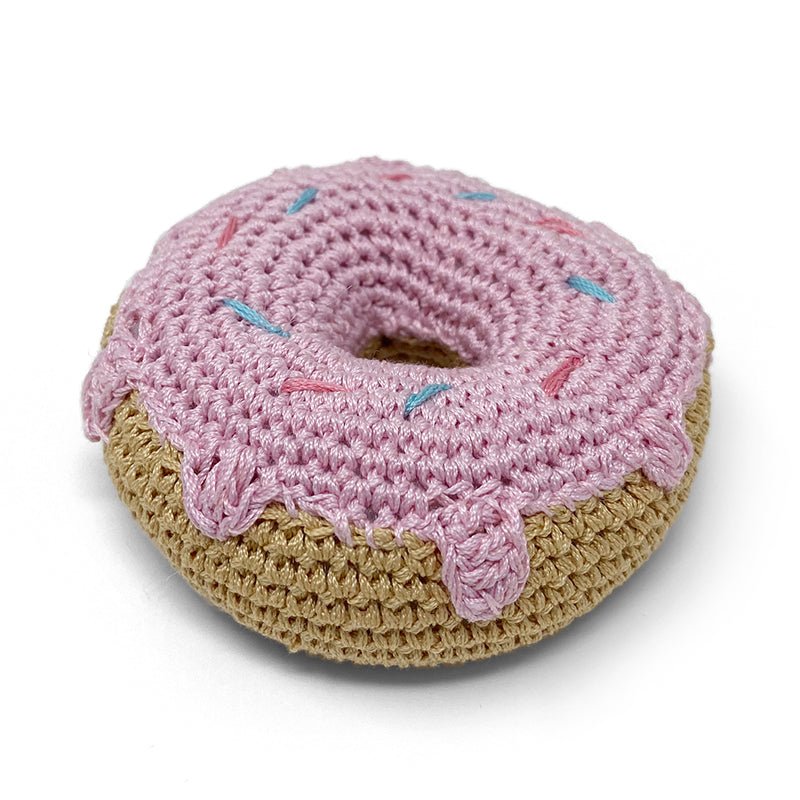Crochet donut toy, pink top with teal sprinkles, beige underside detail