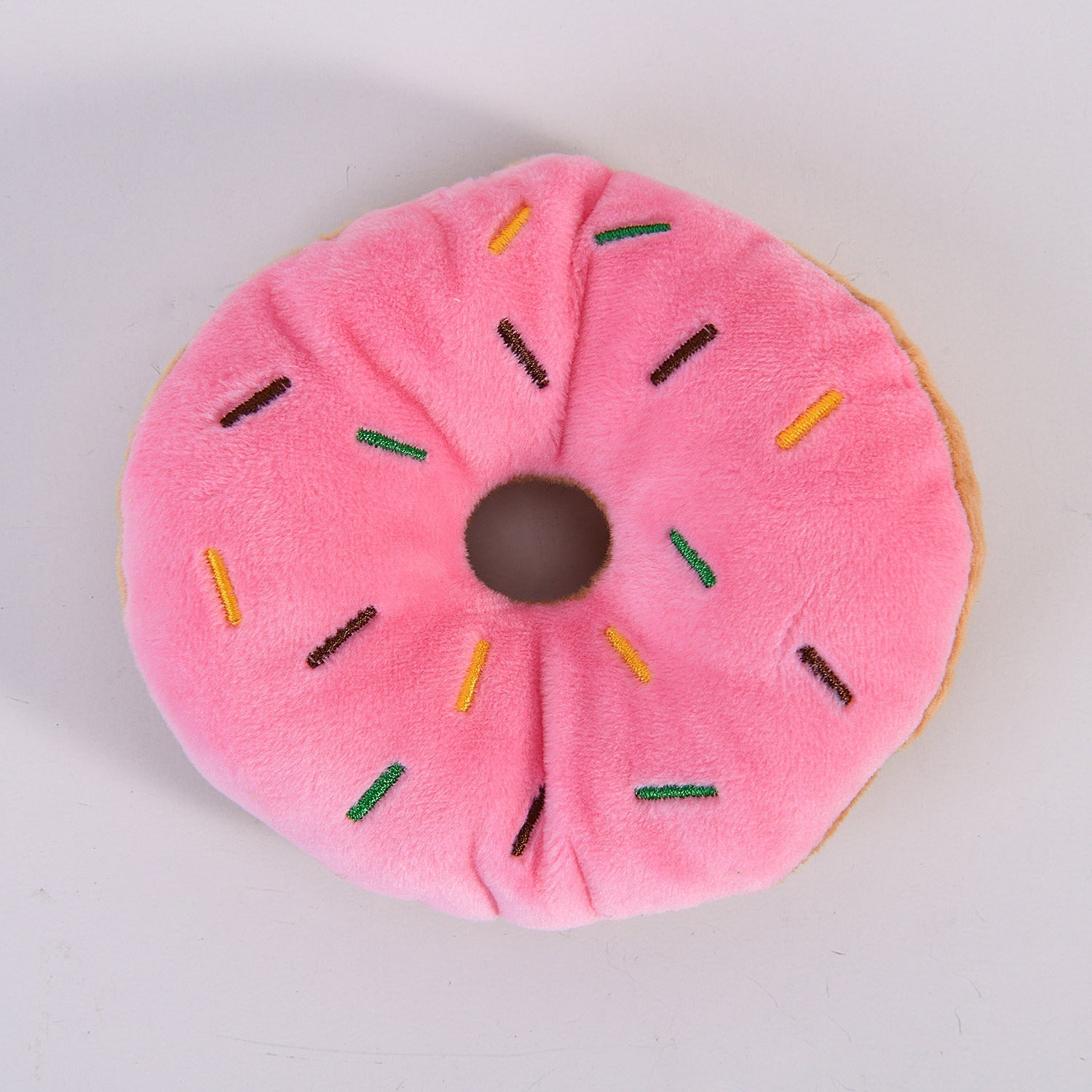 Plush donut dog chew toy, pink round plush with colorful sprinkle details
